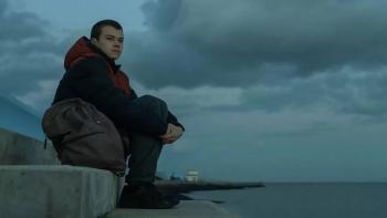 County Lines: A teenage boy sits on a wall overlooking the sea