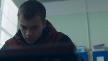 County Lines: A young teenage boy looks down at his desk as he sits in a classroom