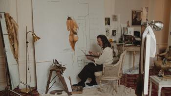 Daliland Movie: Salvador Dali (Ben Kingsley) sits in his studio painting a picture of a woman's nude backside