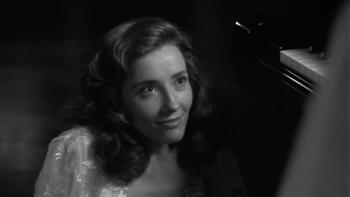 Dead Again: Emma Thompson is shown in close-up wearing a white dress against a pitch black background