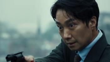 Decision to Leave: A Korean police man stands with gun drawn