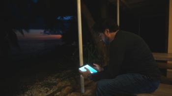 Deepfaking Sam Altman Movie: Adam Bhala Lough sits in the dark looking contemplatively at a glowing screen