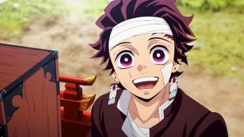 Tanjiro rides on a decorative wooden cart, although he is injured, he expresses excitement at the people cheering him on.