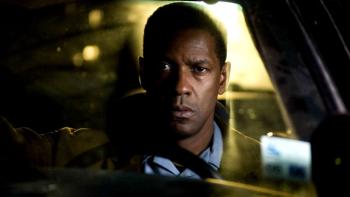 Deja Vu Movie: Denzel Washington sits in shadow inside a car