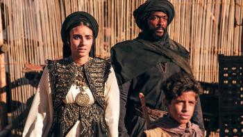 Desert Warrior Movie: Princess Hind speaks, trying to rally the people, while the Bandit and a young boy look on