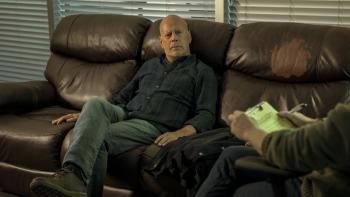 Detective Knight: Independence Movie: Bruce Willis sits on a couch while speaking to a therapist, who partly appears on the right
