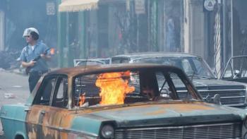 Detroit Movie: A burning car in the streets of Detroit