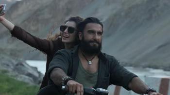Dhurandhar movie: A man and woman on a motorbike smiling and taking a selfie