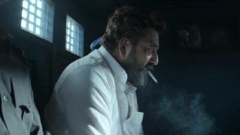 Dhurandhar movie: A middle-aged man sitting in a darkened van smoking, another man, whose head is out of shot, sitting next to him