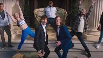 Dicks: The Musical: People in the city are dancing with two White Millennial men in the center of it all