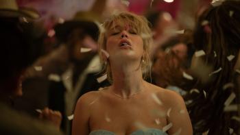 Die My Love movie: Jennifer Lawrence is lost in the music on the dance floor in a fancy dress, confetti blowing through the air