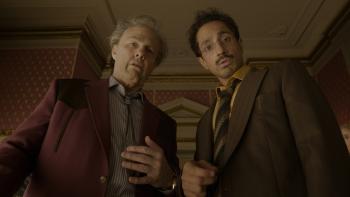 Digger movie: Rockwell (Tom Cruise) and Dr. Ganesh (Riz Ahmed) look startled at something beneath them