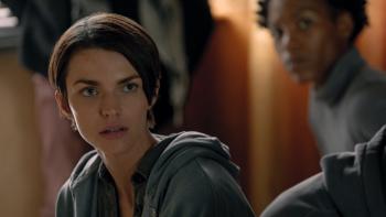 Dirty Angels movie: Close up of Ruby Rose wearing a hoodie, with Jojo T. Gibbs in the background