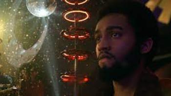 Disco Inferno scene 3: A Black man at the disco looking somber