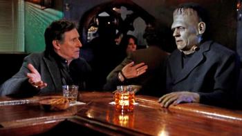 Death of a Ladies' Man: An older White man sits a bar having a drink with Frankenstein