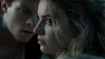 Do Not Enter Movie: Two people in dim light, with serious expressions, close to each other.