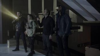 Do Not Enter Movie: Four people exploring a dark building with flashlights.