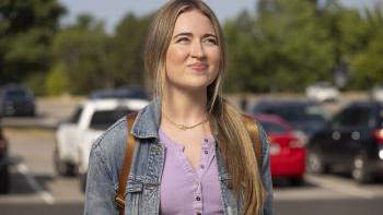 Dot Conner: Webtective movie: Gili Gould stands in a parking lot with a backpack on