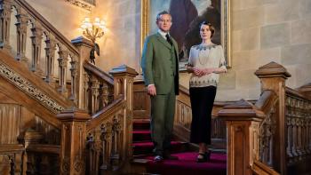 Downton Abbey: A New Era Movie: A man and a woman standing on a staircase