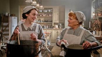 Downton Abbey: A New Era Movie: Two women talking to each other while stirring large stockpots