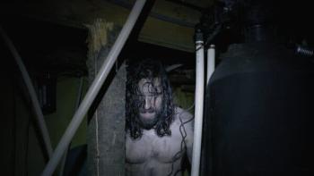 Dream Eater Movie: A shirtless, scared-looking Alex appears behind a beam in the crawlspace under the cabin