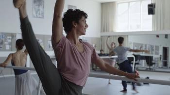 Dreams movie: Isaac Hernandez stands at a ballet barre with his leg raised