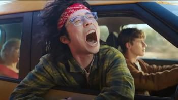Driver's Ed movie: Aidan Laprete, a teen with glasses, screams with his head hanging out the window of a moving car