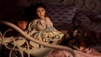 Dust Bunny Movie: Aurora (Sophie Sloan) sits up in bed, visibly concerned
