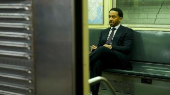 The Dutchman Movie: Clay (André Holland), in a suit and tie, rides the subway