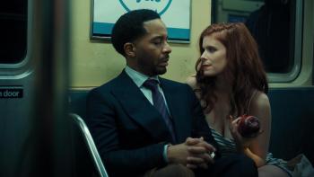The Dutchman Movie: Clay (André Holland) looks uncomfortable as Lula (Kate Mara), who holds an apple, sits very close to him on a train
