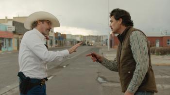 Eddington Movie: Sheriff Joe Cross (Joaquin Phoenix) and Mayor Ted Garcia (Pedro Pascal) stand on the street and argue, pointing and gesturing