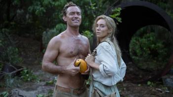 Eden movie: Jude Law, shirtless, stands with a large fruit in his hand; Vanessa Kirby stands close to him