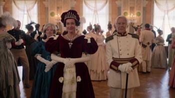 Ehrengard: The Art of Seduction movie: In a regal ballroom, many Danish people mill about behind the Grand Duchess white woman in dark red and white dress center and a Danish white man in white military suit right