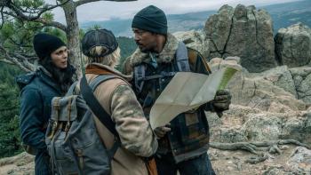 Elevation movie: Morena Baccarin, Maddie Hasson, and Anthony Mackie look at a map in the woods