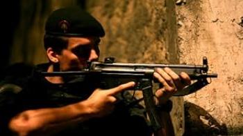 Elite Squad: A police man peeks around a wall at night pointing a machine gun