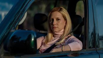 Elize: Shadows of a Woman movie: Woman with blonde hair driving a car, looking forward, wearing a seatbelt.