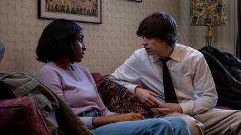 Ella McCay movie: Susan (Ayo Edebiri) sits on a couch while Casey (Spike Fearn) explains himself to her