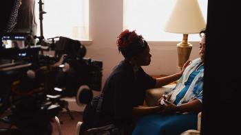 Emanuel Movie: Two women comfort each other in a suburban living room