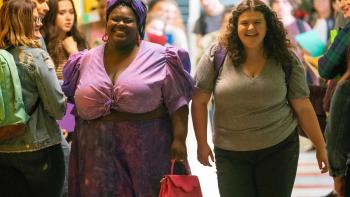 Empire Waist movie: Best friends Kayla (Jemima Yevu) and Lenore (Mia Kaplan) walk in the school hallway