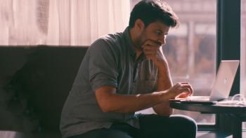 Reporter Oliver Laughland writing on laptop.