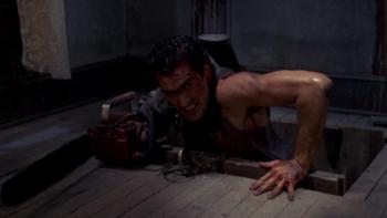 Evil Dead II Movie: Now with his chainsaw arm, Ash pulls himself out of the cellar with his other arm