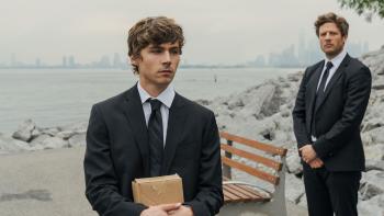 Ex-Husbands movie: Miles Heizer solemnly holds a box by the Hudson River while James Norton looks on