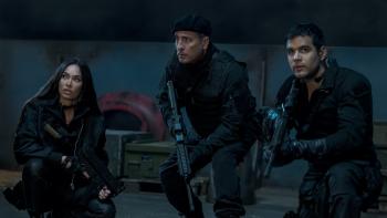 Expend4bles Movie: Gina (Megan Fox), Marsh (Andy Garcia), and Galan (Jacob Scipio) crouch, holding rifles, aboard an enemy ship