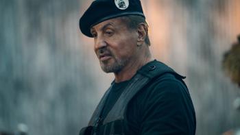 Expend4bles Movie: Barney Ross (Sylvester Stallone), wearing his Expendables cap and flak vest, poses alone