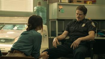 F Marry Kill: Lucy Hale leans forward to make a report to a mustachioed police officer