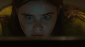 Faces of Death Movie: Margot (Barbie Ferreira) looks shocked as light from her computer screen illuminates her face