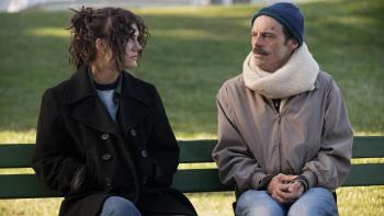 Fairyland Movie: Older Alysia sits on a park bench next to her father, who looks frail and sick