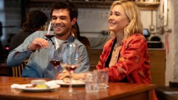 Falling movie: Two people sit at a table, having wine and smiling/laughing