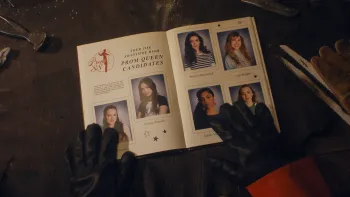 Fear Street: Prom Queen movie: From killer's perspective, black-gloved hands look at a 1988 high school yearbook open to "Prom Queen Candidates" page