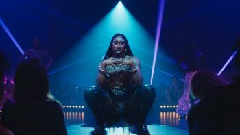 Femme: Nathan Stewart-Jarrett performs as his drag persona, crouched down on the edge of the stage illuminated by a blue spot